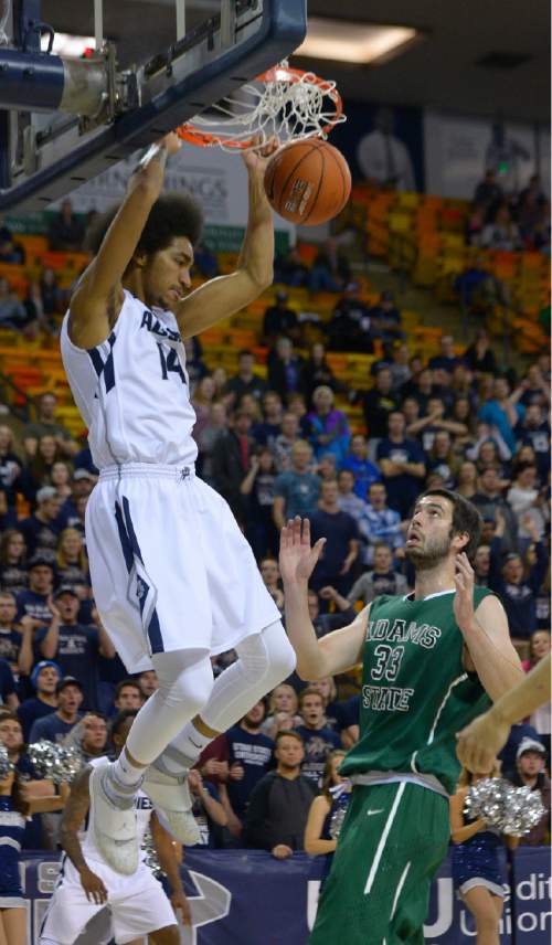 Leah Hogsten  |  The Salt Lake Tribune
Utah State Aggies forward Jalen Moore (14) dunks on Adam State Grizzlies forward Ante Mioc (33).Utah State Aggies leads Adams State Grizzlies, 47-27, Tuesday, November 17, 2015 at Smith Spectrum.