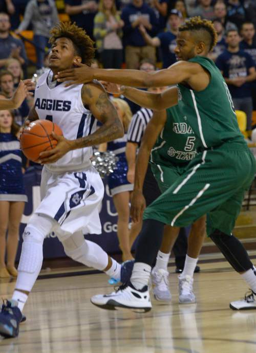 Leah Hogsten  |  The Salt Lake Tribune
Utah State Aggies guard Shane Rector (4) slips past Adams State Grizzlies guard EJ Hubbard II (0) to the net. Utah State Aggies leads Adams State Grizzlies, 47-27, Tuesday, November 17, 2015 at Smith Spectrum.