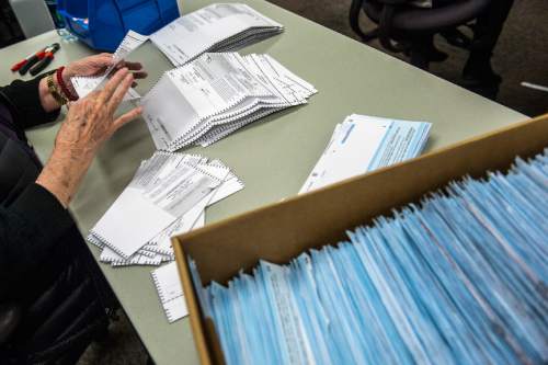 Chris Detrick  |  The Salt Lake Tribune
Noreen Nielson opens and prepares ballots for tabulation at the Salt Lake County Government Center Wednesday November 4, 2015.