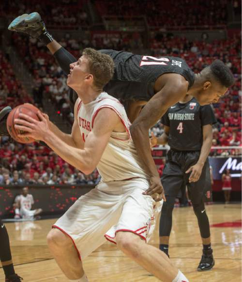 Rick Egan  |  The Salt Lake Tribune

Utah Utes forward Jakob Poeltl (42) goes up for a shot, as San Diego State Aztecs forward Malik Pope (21) tumbles off his back, in basketball action, as the Utes defeated the San Diego State Aztecs 81-76, at the Huntsman Center, Tuesday, November 10, 2015.