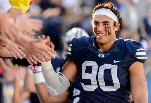 Trent Nelson  |  The Salt Lake Tribune
Brigham Young Cougars defensive lineman Bronson Kaufusi (90) high-fives fans after the 70-6 win as BYU hosts Wagner, NCAA football at LaVell Edwards Stadium in Provo, Saturday October 24, 2015.