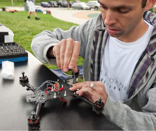 Michael Mangum  |  Special to the Tribune

Tyler Christensen, of Alpine, assembles an Airborne Racing Grand Prix 250mm-class drone before the beginning of the first Utah Cup drone race at Warm Springs Park in Salt Lake City on Saturday, October 10, 2015.