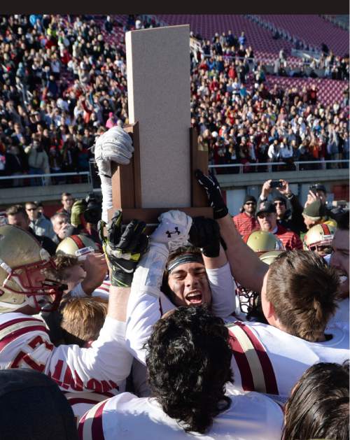 Steve Griffin  |  The Salt Lake Tribune

Logan players hold up the championship trophy after defeating Dixie in  the Class 3AA state football championship game at Rice-Eccles Stadium in Salt Lake City, Friday, November 20, 2015.  Logan defeated Dixie to win the championship.
