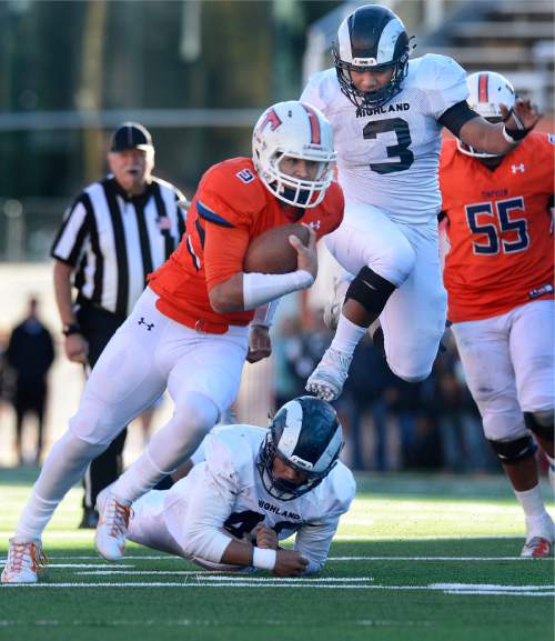 Scott Sommerdorf   |  The Salt Lake Tribune
Timpview QB Kahi Neves runs past Highland's leaping LB Talo Latu during first half play. Timpview led Highland 21-19 at the half in a 4A semi-final game played at Rice-Eccles stadium, Thursday, November 12, 2015.