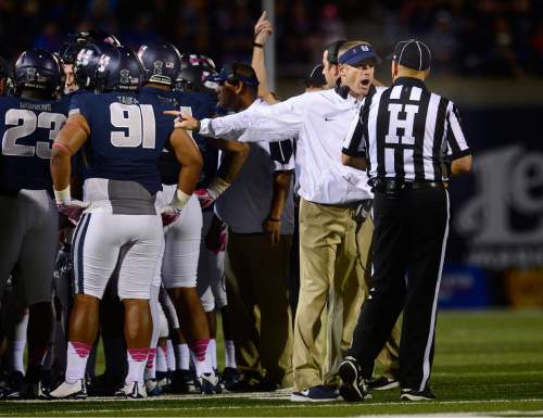 Scott Sommerdorf   |  The Salt Lake Tribune
Utah State Aggies head coach Matt Wells makes a point with head linesman Mike Moeller during a first quarter time out. Utah State led Boise State 17-3 after one quarter of play, Friday, October 15, 2015.