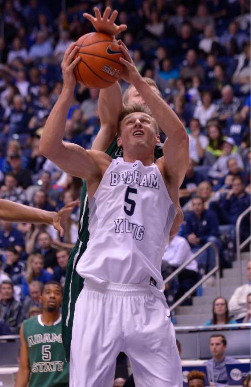 Leah Hogsten  |  The Salt Lake Tribune
Brigham Young Cougars guard Kyle Collinsworth (5) is fouled by Adams State Grizzlies forward Ethan Caton (15). Brigham Young University leads Adams State Grizzlies, 42-29 at the halfNovember 20, 2015 at Marriott Center, Provo.