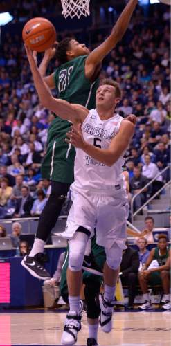 Leah Hogsten  |  The Salt Lake Tribune
Brigham Young Cougars guard Kyle Collinsworth (5) rounds Adams State Grizzlies forward Bryan Umoru (21) for two. Brigham Young University leads Adams State Grizzlies, 42-29 at the halfNovember 20, 2015 at Marriott Center, Provo.