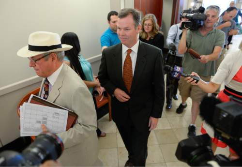 Francisco Kjolseth | The Salt Lake Tribune
Former Utah Attorney General John Swallow, center,  exits the courtroom into awaiting media at the Matheson Courthouse in Salt Lake City on Monday, July, 27, 2015, behind his attorney Steve McCaughey for an arraignment hearing. Swallow had his attorney plead not guilty on his behalf to more than a dozen criminal charges of corruption.