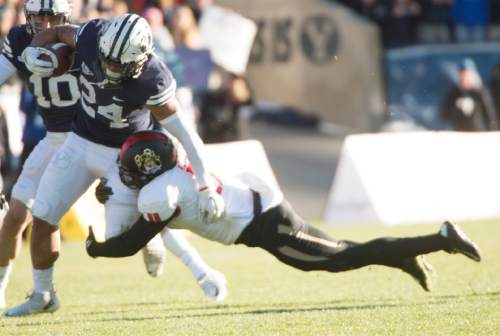 Rick Egan  |  The Salt Lake Tribune

Brigham Young Cougars running back Algernon Brown (24) is brought down by Fresno State Bulldogs defensive back DeShawn Potts (11), as BYU defeated the Fresno Bulldogs 52 -10, at Lavell Edwards stadium, Tuesday, November 21, 2015.