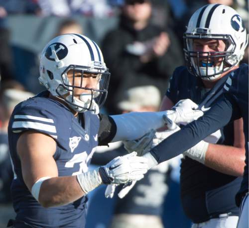 Rick Egan  |  The Salt Lake Tribune

Brigham Young Cougars running back Francis Bernard (36) and Brigham Young Cougars offensive lineman Ryker Mathews (72) celebrate Bernard's touchdown, as BYU defeated the Fresno Bulldogs 52 -10, at Lavell Edwards stadium, Tuesday, November 21, 2015.