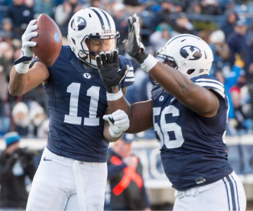 Rick Egan  |  The Salt Lake Tribune

Brigham Young Cougars wide receiver Terenn Houk (11) and Brigham Young Cougars linebacker Zach Newman (56) celebrate Houk's touchdown, as BYU defeated the Fresno Bulldogs 52 -10, at Lavell Edwards stadium, Tuesday, November 21, 2015.