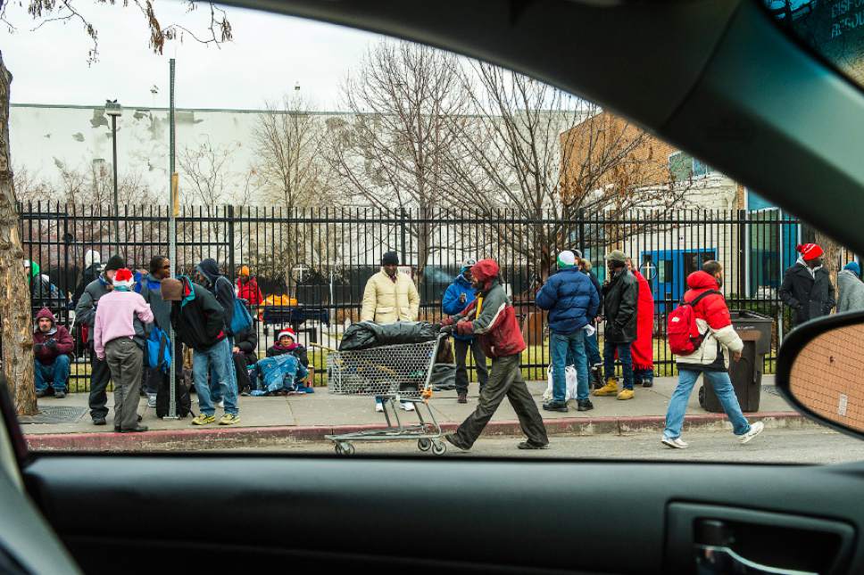 Chris Detrick  | Tribune file photo
Homeless men and women wait outside the Catholic Community Services of Utah in December 2014.