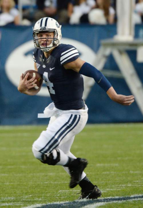 Steve Griffin  |  The Salt Lake Tribune


BYU Cougars quarterback Taysom Hill (4) heads up field for a touchdown during game between BYU and Houston and LaVell Edwards Stadium in Provo, Thursday, September 11, 2014.