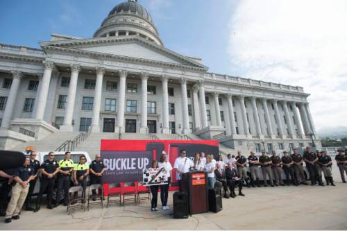 Steve Griffin  |  The Salt Lake Tribune

The Barney family, of South Jordan, Utah, who survived a car crash because they were all wearing seat belts is joined by Utah Highway Patrol troopers, Salt Lake City police officers, legislators and UDOT officials during an event promoting the new law that makes it easier to enforce seat belt requirements. The law takes effect Tuesday. The event was held at the Utah State Capitol in Salt Lake City, Thursday, May 7, 2015.