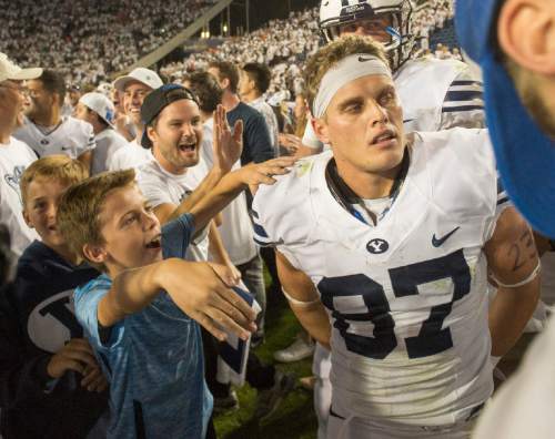 Rick Egan  |  The Salt Lake Tribune

Brigham Young fans try to get to Brigham Young Cougars wide receiver Mitchell Juergens (87), as they storm the field after BYU beat the Broncos 35-24, in college football action, BYU vs. Boise State at Lavell Edwards Stadium, Saturday, September 12, 2015.