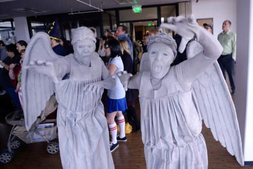 Al Hartmann  |  The Salt Lake Tribune
Harold and Roxanne Weir, dressed as Weeping Angels from the Doctor Who science fiction show applaud in their own scary way as Salt Lake Comic Con cofounders-producers Dan Farr and Brian Brandenburg announce the schedule of special guests for its upcoming FanX convention at a press conference Tuesday Nov. 24.