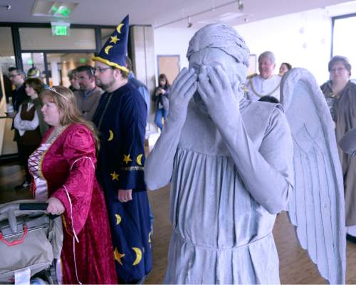 Al Hartmann  |  The Salt Lake Tribune
Harold Weir, dressed as a Weeping Angels from the Doctor Who science fiction show lurks in the room with other characters as Salt Lake Comic Con cofounders-producers Dan Farr and Brian Brandenburg announce the schedule of special guests for its upcoming FanX convention at a press conference Tuesday Nov. 24.