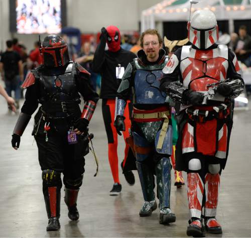 Franciso Kjolseth  |  The Salt Lake Tribune
A team of "custom Mandalorians," played by Brittanie Larsen, left, Daniel Wagner and Dean Derhak march through the crowds as thousands of fiction fans from near and far gather at the Salt Palace Convention Center for day two of Salt Lake Comic Con's FanX.