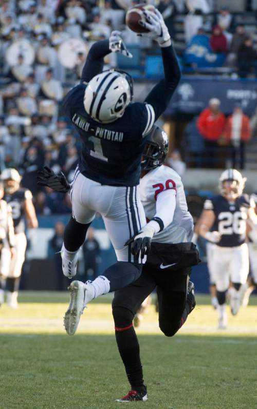 Rick Egan  |  The Salt Lake Tribune

Brigham Young Cougars wide receiver Moroni Laulu-Pututau (1) grabs a pass as Fresno State Bulldogs defensive back Malcolm Washington (20) defends, in football action, BYU vs. The Fresno Bulldogs, at Lavell Edwards stadium, Tuesday, November 21, 2015.