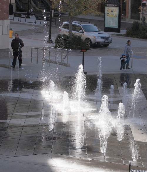 Al Hartmann  |  The Salt Lake Tribune
Shoppers pass by the Olympic fountain Monday Nov. 23 at the Gateway in Salt Lake City.