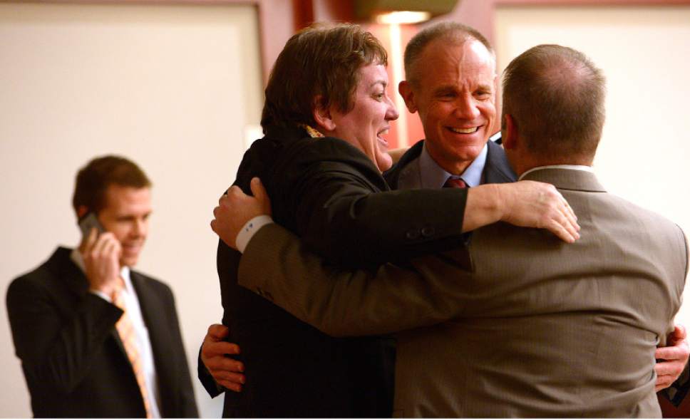 Leah Hogsten  |  The Salt Lake Tribune
l-r Defense attorneys Brad Mumford, Helen Redd, defendant Marc Sessions Jenson and lead attorney Marcus Mumford embrace after he was found not guilty Friday, January 30, 2015 of fraud and money laundering in connection with the failed Mount Holly golf and ski resort near Beaver -- a case with ties to the bribery and corruption investigation of former Utah attorneys general Mark Shurtleff and John Swallow.
Following a three-week trial, a jury of five men and three women deliberated 14 hours over two days before acquitting Jenson of four counts each of second-degree felony communications fraud and money laundering.