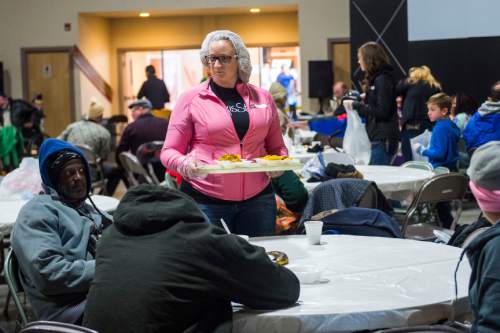Chris Detrick  |  The Salt Lake Tribune
Volunteer Holly Loutensock serves nachos during Salt Lake City Mission's 22nd annual Thanksgiving Day Dinner For The Homeless at the Christian Life Center Thursday November 26, 2015.