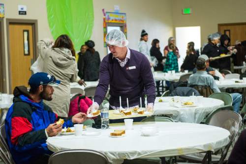 Chris Detrick  |  The Salt Lake Tribune
Volunteer Ben Angell serves pumpkin pie during Salt Lake City Mission's 22nd annual Thanksgiving Day Dinner For The Homeless at the Christian Life Center Thursday November 26, 2015.