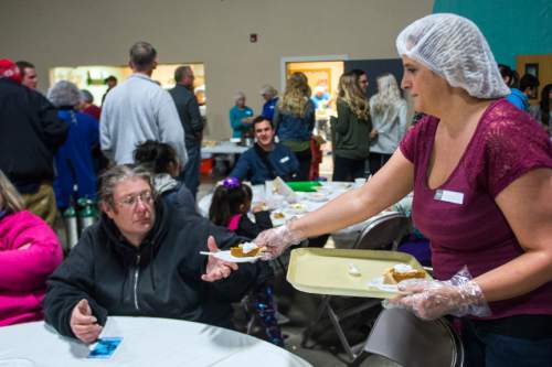 Chris Detrick  |  The Salt Lake Tribune
Volunteer Heather Watkins serves pumpkin pie during Salt Lake City Mission's 22nd annual Thanksgiving Day Dinner For The Homeless at the Christian Life Center Thursday November 26, 2015.