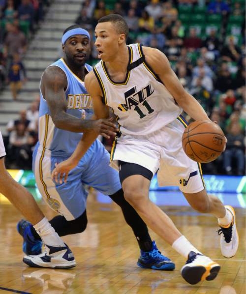 Steve Griffin  |  The Salt Lake Tribune

Utah Jazz guard Dante Exum (11) drives past Denver Nuggets guard Ty Lawson (3) during first half action in the Jazz versus Nuggets NBA game at EnergySolutions Arena in Salt Lake City, Wednesday, April 1, 2015.