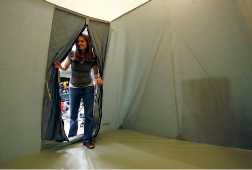 Steve Griffin  |  The Salt Lake Tribune

Corinne Schmidt, of Taylorsville, checks out a Springbar tent at Kirkhams Outdoor Products in Salt Lake City Wednesday Jun 10, 2009.  Schmidt purchased this tent for an upcoming camping trip.