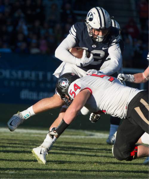 Rick Egan  |  The Salt Lake Tribune

Brigham Young Cougars defensive back Kai Nacua (12) is brought down by Fresno State Bulldogs offensive lineman Justin Northern (54), after intercepting a Bullldog pass,  as BYU defeated the The Fresno Bulldogs 52 -10, at Lavell Edwards stadium, Tuesday, November 21, 2015.