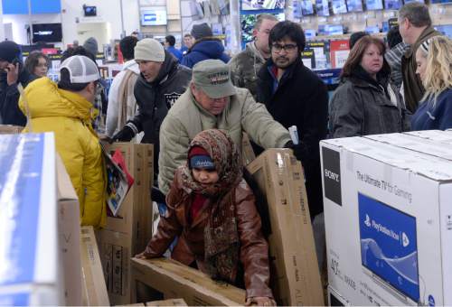 Al Hartmann  |  The Salt Lake Tribune
Hundreds of customers that waited outside Salt Lake City's 2100 S. 300 W. Best Buy store enter the doors at 5 p.m. Thursday Nov. 26 to take advantage for special deals.  Many went for the big screen TV's.