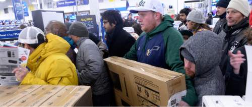 Al Hartmann  |  The Salt Lake Tribune
Hundreds of customers that waited outside Salt Lake City's 2100 S. 300 W. Best Buy store enter the doors at 5 p.m. Thursday Nov. 26 to take advantage for special deals.  Many went for the big screen TV's.