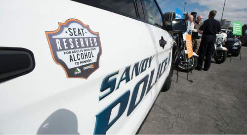 Steve Griffin  |  The Salt Lake Tribune

Sandy city police cars are featuring a printed reminder that says: "Seat reserved for adults who give alcohol to minors." The graphic message was unveiled at a press conference at the Sandy City Police Department on Monday, April 27, 2015.