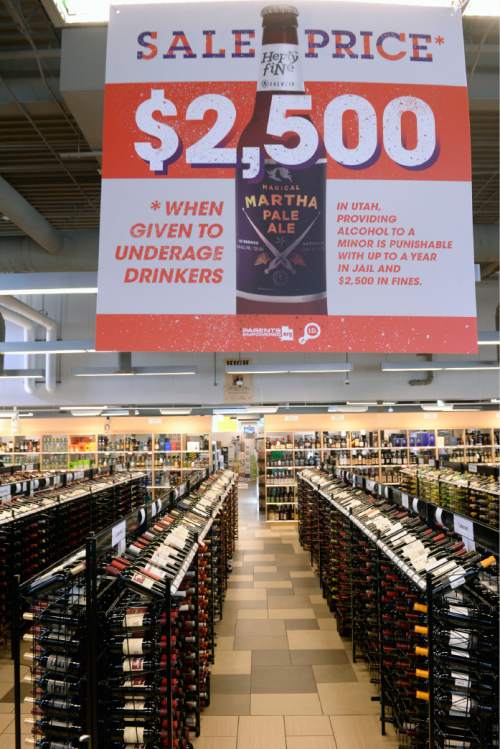 Al Hartmann |  Tribune file photo
Posters and tags hanging from liquor bottles remind patrons of the legal and financial costs of supplying alcohol to those who are underage at the Utah State Liquor Store at 1814 E. Murray Holladay Road on Thursday July 2.
MADD, DABC and Parents Empowered introduced the new ad campaign to curb underage drinking . The campaign will eventually be displayed at all 44 stores this Summer.
