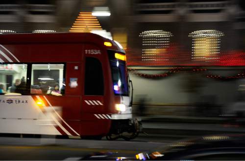 Scott Sommerdorf   |  The Salt Lake Tribune
A TRAX train blurs by the holiday lights on Temple Square, Friday, November 27, 2015.
