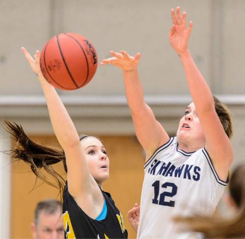 Trent Nelson  |  The Salt Lake Tribune
Salem Hills's Lauren Gustin (12) blocks a shot by Roy's Sariah Jones (32), as Salem Hills faces Roy in the 4A state high school girls basketball tournament at Salt Lake Community College in Taylorsville, Tuesday February 17, 2015. Mountain View wins 54-49.
