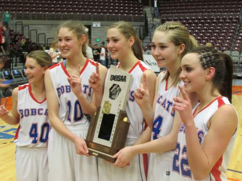 (Tom Wharton  |  The Salt Lake Tribune)
Panguitch starters Catania Holman, Darri Frandsen, Chesney Campbell, Taylor Bennett and Whitni Orton hold Class 1A girls' state championship trophy after beating Bryce Valley 51-29 Saturday night.