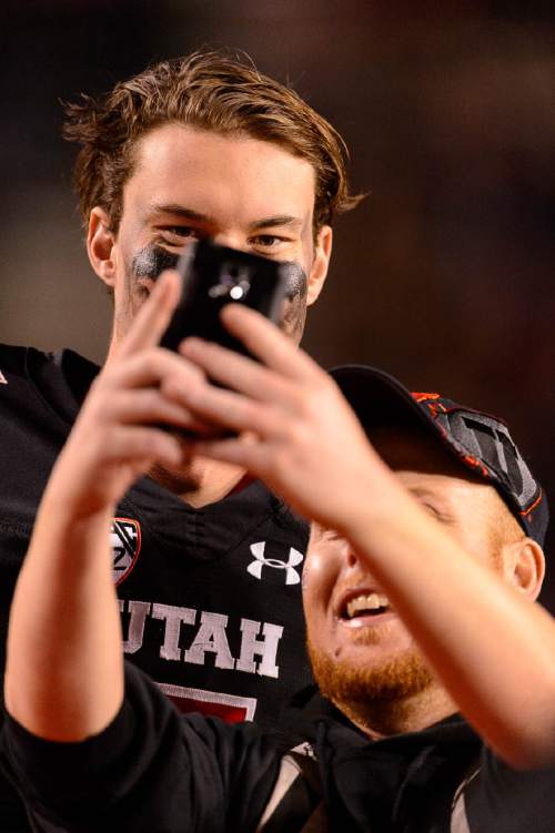 Trent Nelson  |  The Salt Lake Tribune
Utah Utes quarterback Travis Wilson (7) poses for a selfie with a fan after the game as the University of Utah hosts Oregon State, NCAA football at Rice-Eccles Stadium in Salt Lake City, Saturday October 31, 2015.