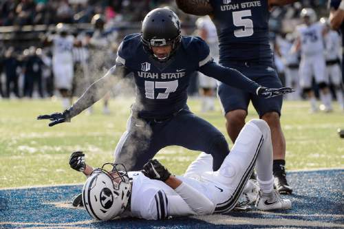 Trent Nelson  |  The Salt Lake Tribune
Utah State Aggies cornerback Deshane Hines (17) stands over Brigham Young Cougars wide receiver Nick Kurtz (5) after he couldn't pull in a touchdown pass as Utah State hosts BYU, NCAA football in Logan, Saturday November 28, 2015. Utah State Aggies linebacker LT Filiaga (5) at right.