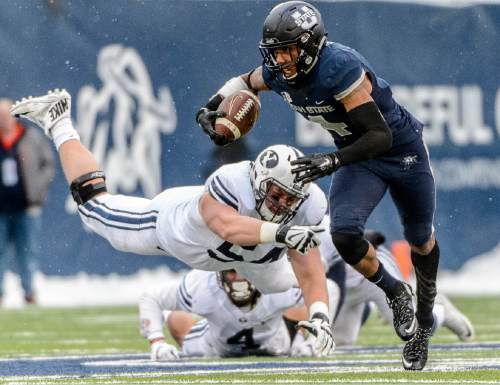 Trent Nelson  |  The Salt Lake Tribune
Brigham Young Cougars offensive lineman Parker Dawe (54) dives after Utah State Aggies wide receiver Hunter Sharp (4) as Utah State hosts BYU, NCAA football in Logan, Saturday November 28, 2015.