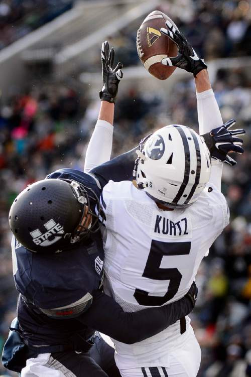Trent Nelson  |  The Salt Lake Tribune
Brigham Young Cougars wide receiver Nick Kurtz (5) bobbles what would have been a touchdown pass as Utah State hosts BYU, NCAA football in Logan, Saturday November 28, 2015. Utah State Aggies cornerback Deshane Hines (17) defending on the play.