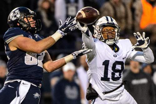 Trent Nelson  |  The Salt Lake Tribune
Brigham Young Cougars defensive back Michael Shelton (18) knocks the ball away from Utah State Aggies wide receiver Andrew Rodriguez (82) as Utah State hosts BYU, NCAA football in Logan, Saturday November 28, 2015.
