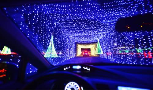 Steve Griffin  |  The Salt Lake Tribune

Patrons enjoy a mile-long drive-through holiday light show extravaganza in Kearns. "Christmas in Color," which syncs nearly 1 million LED lights to seasonal music, is the creation of Animated Color, founded by renowned Utah lighting artist Richard Holdman. The light show is located in the parking lot of the Utah Olympic Oval in Kearns, Wednesday, November 25, 2015.
