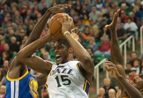 Rick Egan  |  The Salt Lake Tribune

Utah Jazz forward Derrick Favors (15) tries to get a shot off, as he is guarded by Golden State Warriors forward Draymond Green (23) and Golden State Warriors center Festus Ezeli (31), in NBA action the Utah Jazz vs. the Golden State Warriors, in Salt Lake City, Monday, November 30, 2015.