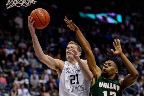 Trent Nelson  |  The Salt Lake Tribune
Brigham Young Cougars forward Kyle Davis (21) puts up a shot, defended by Mississippi Valley State Delta Devils forward Jabari Alex (13), as BYU hosts Mississippi Valley State, NCAA basketball at the Marriott Center in Provo, Wednesday November 25, 2015.