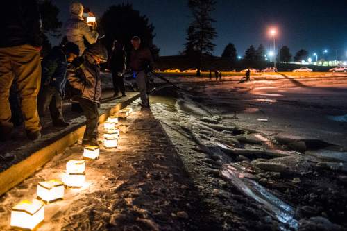 Chris Detrick  |  The Salt Lake Tribune
Water lanterns are lit along the pond as a gesture of solidarity with refugee families during the #JustLikeUs Water Lantern Festival at Sugar House Park Tuesday December 1, 2015.  The #JustLikeUs campaign brings communities together in support of a humanitarian response to the worst refugee crisis since World War II, which is due to war, enduring political crises, and natural disasters.