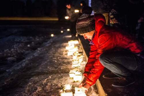 Chris Detrick  |  The Salt Lake Tribune
Sarah Shebek, of Salt Lake City, lights a lantern along the pond as a gesture of solidarity with refugee families during the #JustLikeUs Water Lantern Festival at Sugar House Park Tuesday December 1, 2015.  The #JustLikeUs campaign brings communities together in support of a humanitarian response to the worst refugee crisis since World War II, which is due to war, enduring political crises, and natural disasters.