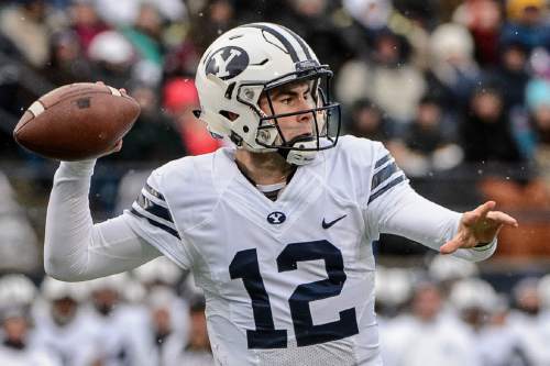 Trent Nelson  |  The Salt Lake Tribune
Brigham Young Cougars quarterback Tanner Mangum (12) throws the ball as Utah State hosts BYU, NCAA football in Logan, Saturday November 28, 2015.