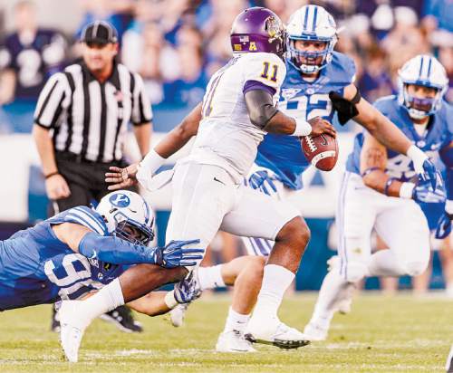 Trent Nelson  |  The Salt Lake Tribune
Brigham Young Cougars defensive lineman Bronson Kaufusi (90) and Brigham Young Cougars defensive lineman Graham Rowley (92) pressure East Carolina Quarterback Cody Keith as BYU hosts East Carolina, college football at LaVell Edwards Stadium in Provo, Saturday October 10, 2015.